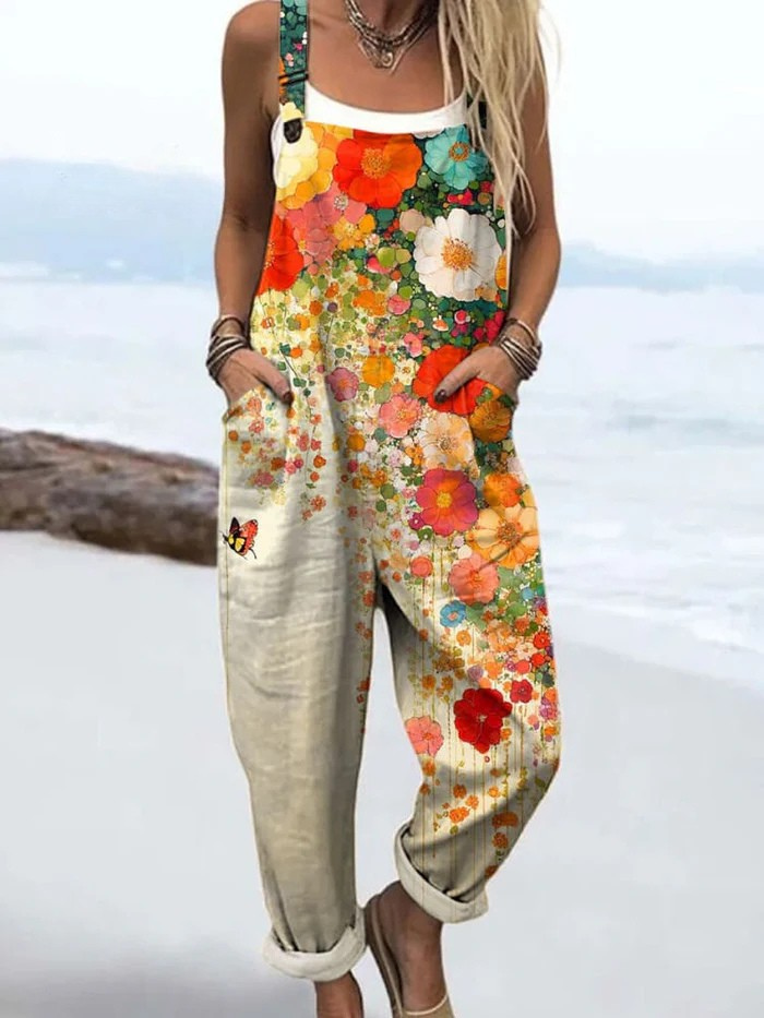 Wildflower Breeze floral jumpsuit styled with a white top beside the coast